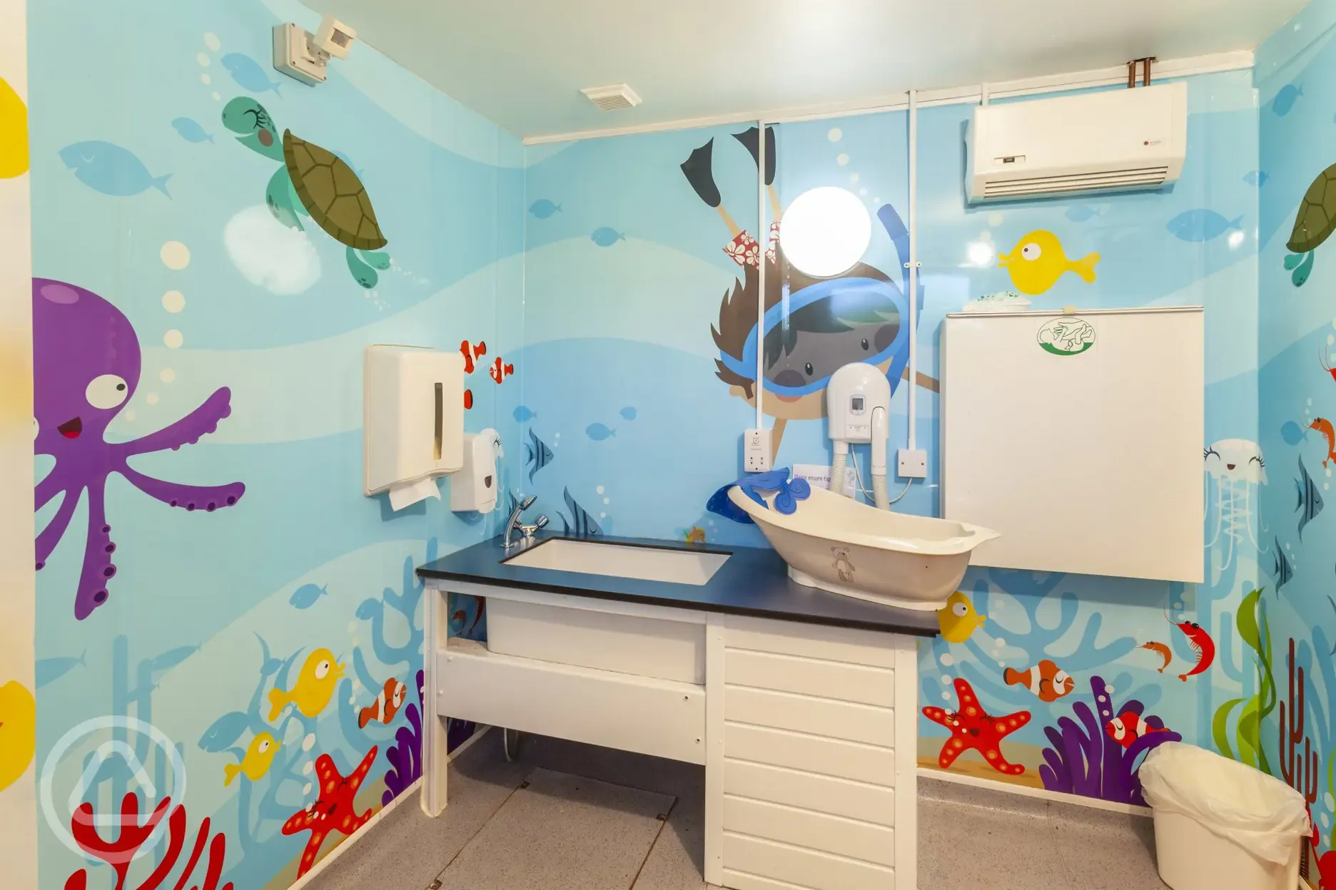 Family bathroom with a baby changing area