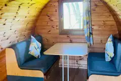 Super camping pod interior with convertible table to a double bed Super camping pod interior with convertible table to a double bed