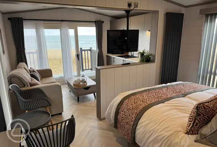 Ensuite glamping cabin with a double bed, living room, and kitchenette