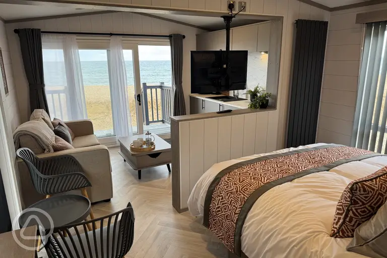 Ensuite glamping cabin with a double bed, living room, and kitchenette