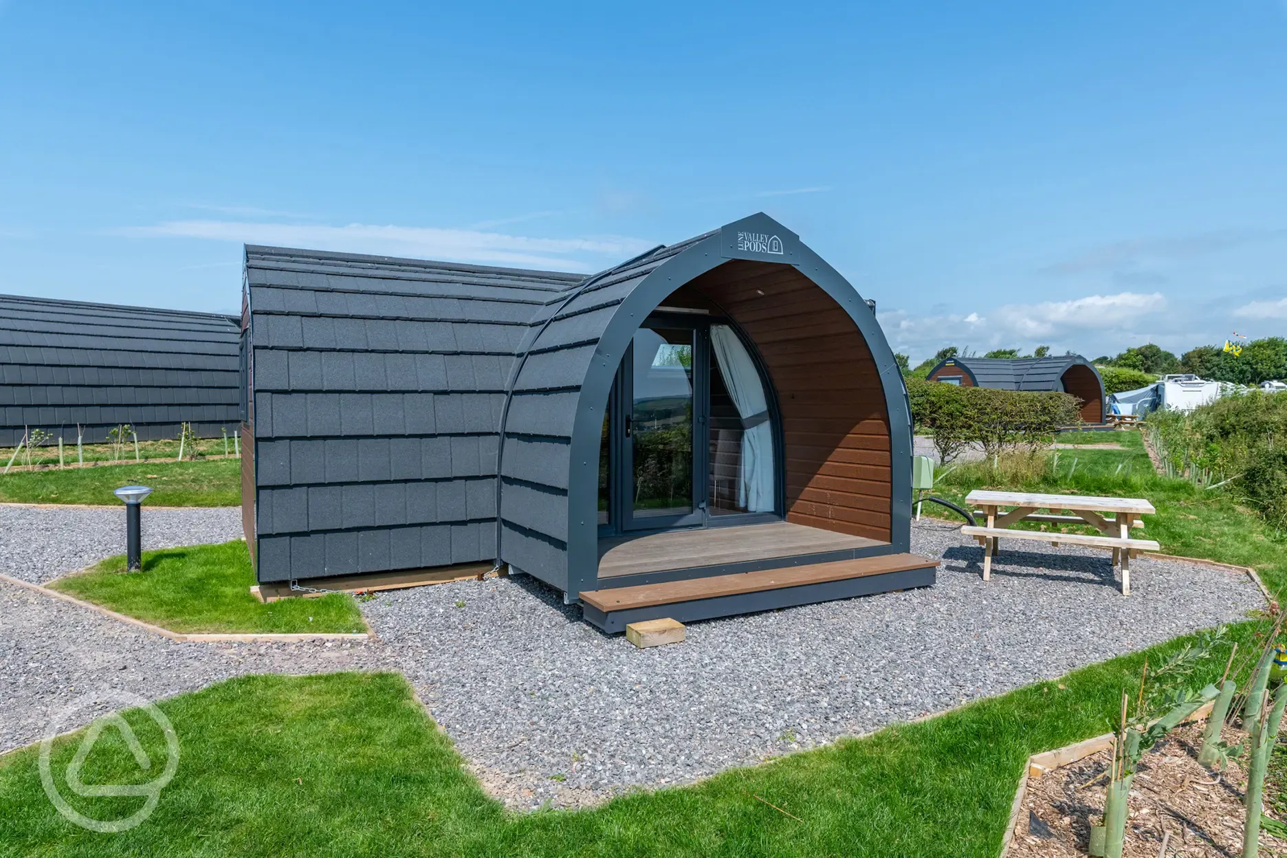 Gold glamping pod exterior with outdoor seating