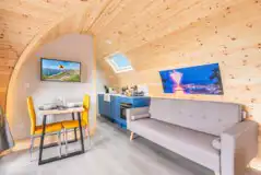 Gold glamping pod, sleeping two with a double bed and luxury interior