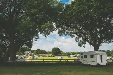 Shady caravan pitches Red Shoot Camping Park Ringwood