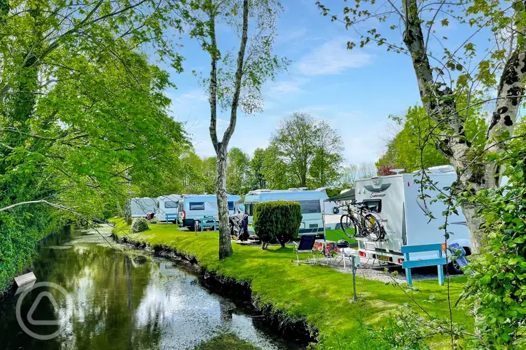 Electric hardstanding touring pitches by the River Yeo