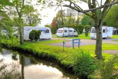 Electric hardstanding touring pitches (9m x 9m) by the River Yeo