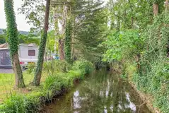 Electric hardstanding touring pitches by the River Yeo Electric hardstanding touring pitches by the River Yeo