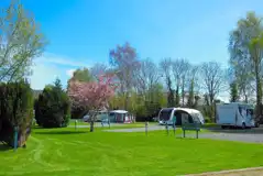 Electric hardstanding touring pitches with grassed areas between