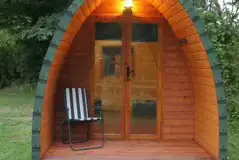 Camping pod with double glass doors and an outdoor light Camping pod with double glass doors and an outdoor light