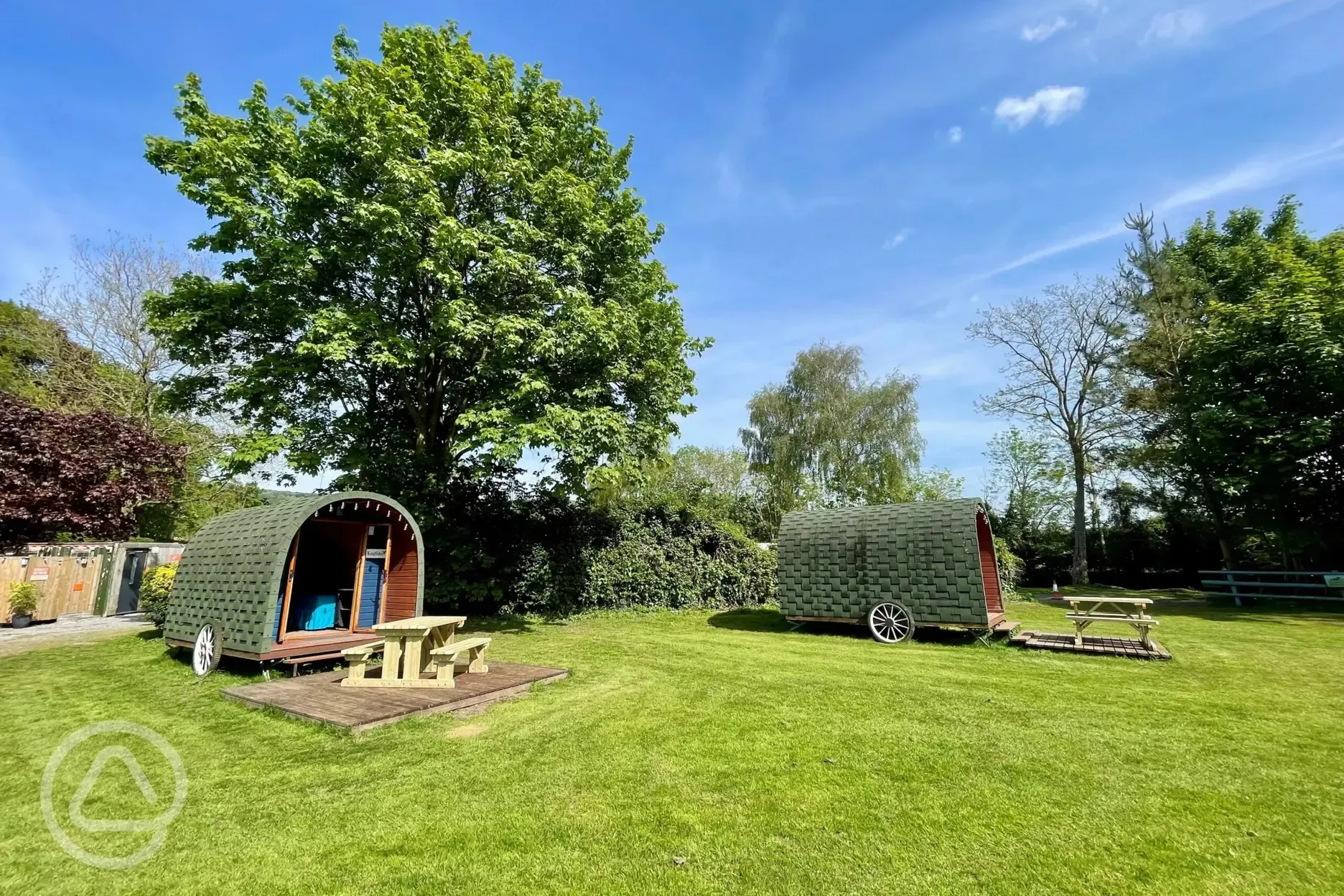 Camping pods with decking areas and picnic benches
