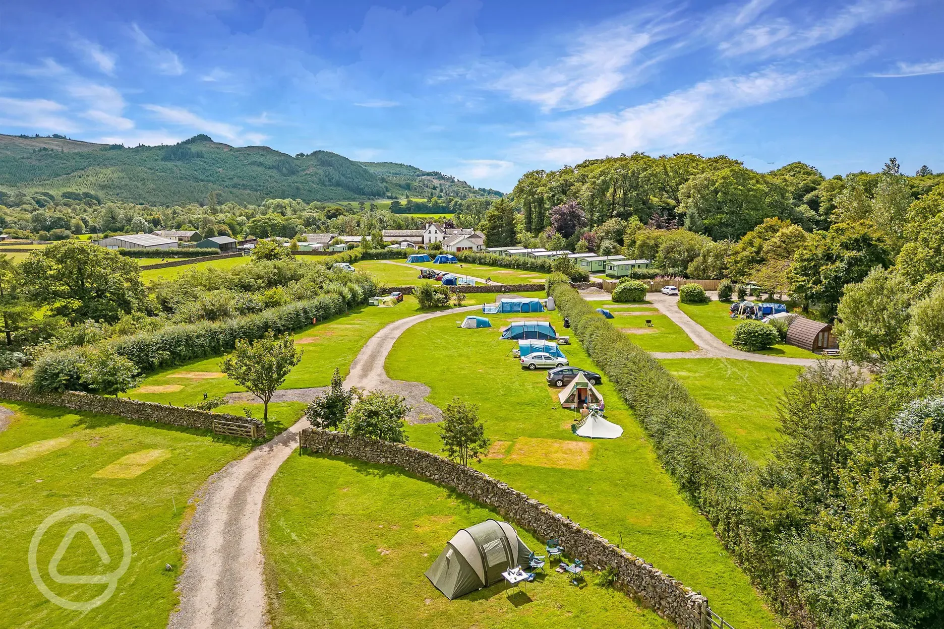 Aerial of grass pitches with dividing walls/hedges between fields