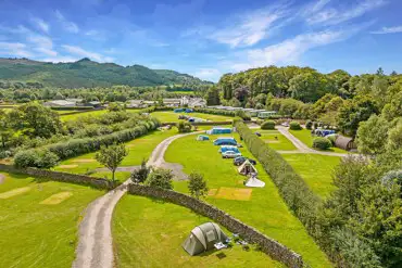 Aerial of grass pitches with dividing walls/hedges between fields