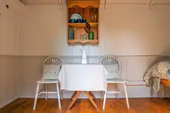 Shepherd's hut interior with a table and chairs Shepherd's hut interior with a table and chairs