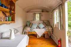 Shepherd's hut interior with a double sofa bed and bedding Shepherd's hut interior with a double sofa bed and bedding