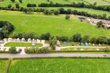 Aerial view of grass and hardstanding pitches at Street Head Caravan Park