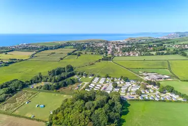 Aerial of Graston Copse Holiday Park and distant views of Hive Beach