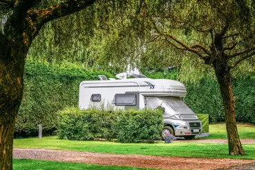 Electric hardstanding touring pitches with privacy hedging
