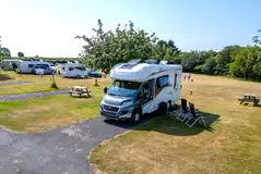 Hardstanding pitches with surrounding grass areas Hardstanding pitches with surrounding grass areas