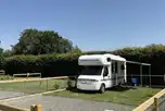 Enclosed hardstanding and grass pitch