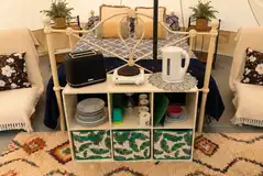 Bell tent interior with a double bed and two futons Bell tent interior with a double bed and two futons