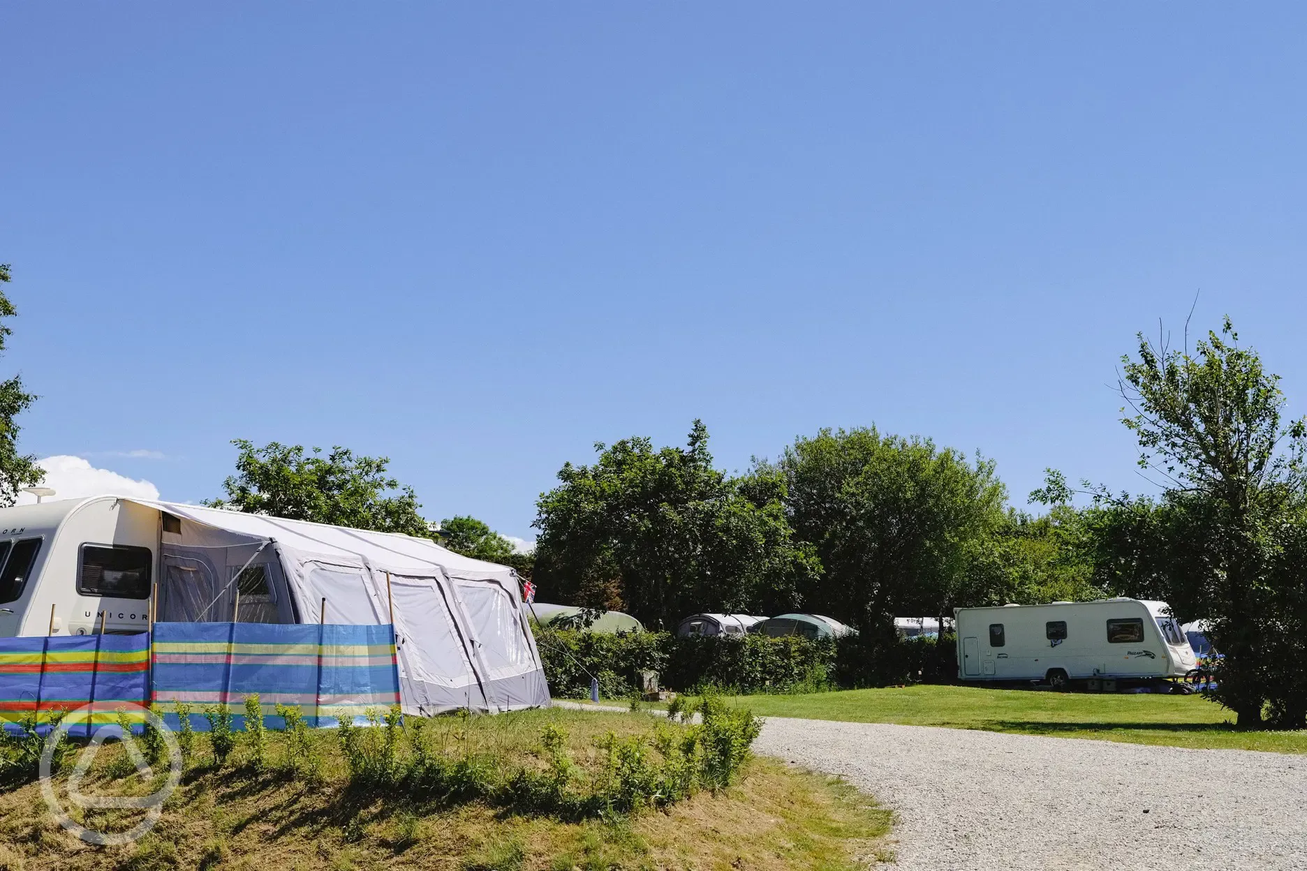 Electric grass and gravel touring pitches at Cornish Coasts