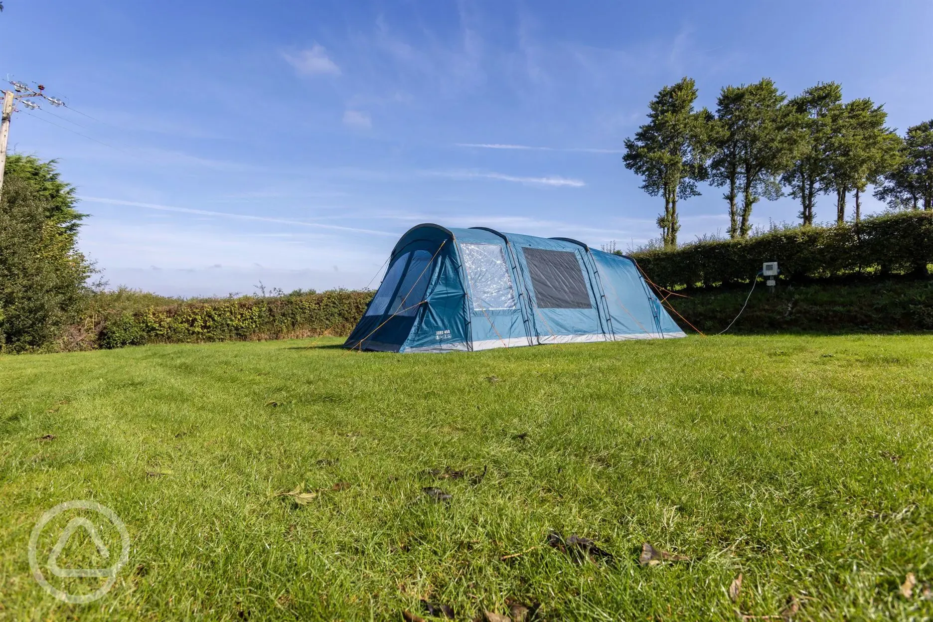 Tent on electric grass pitches at Cornish Coasts Caravan and Camping Park