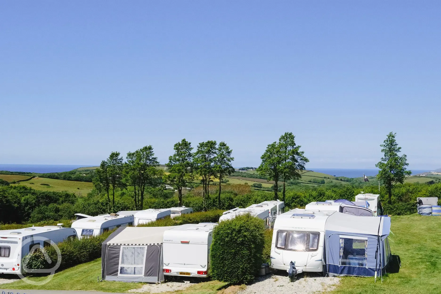 Electric grass and gravel touring pitches with awning space and sea views