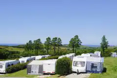 Electric grass and gravel touring pitches with awning space and sea views Electric grass and gravel touring pitches with awning space and sea views