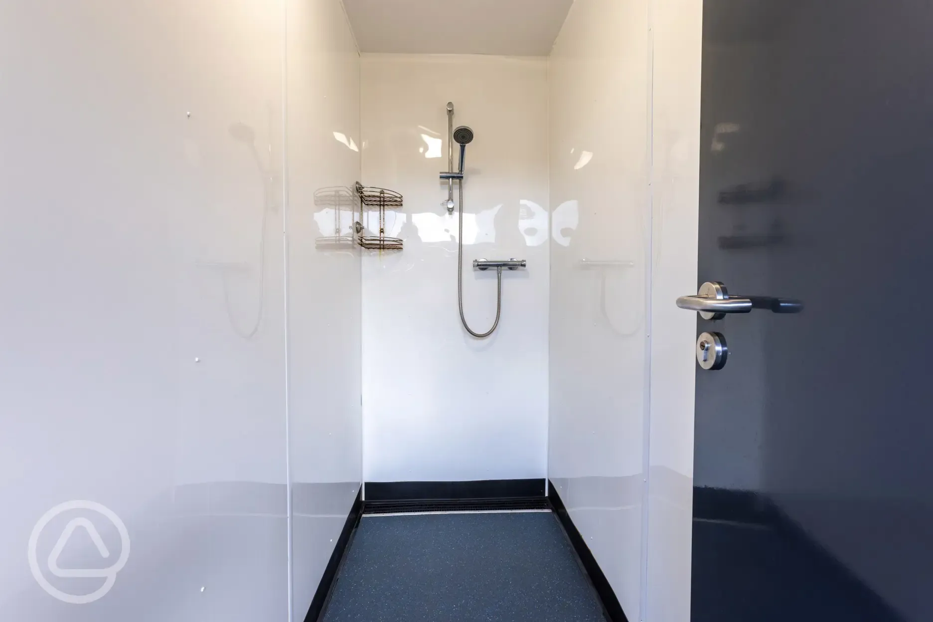 Showers at Cornish Coasts with small shelves for toiletries