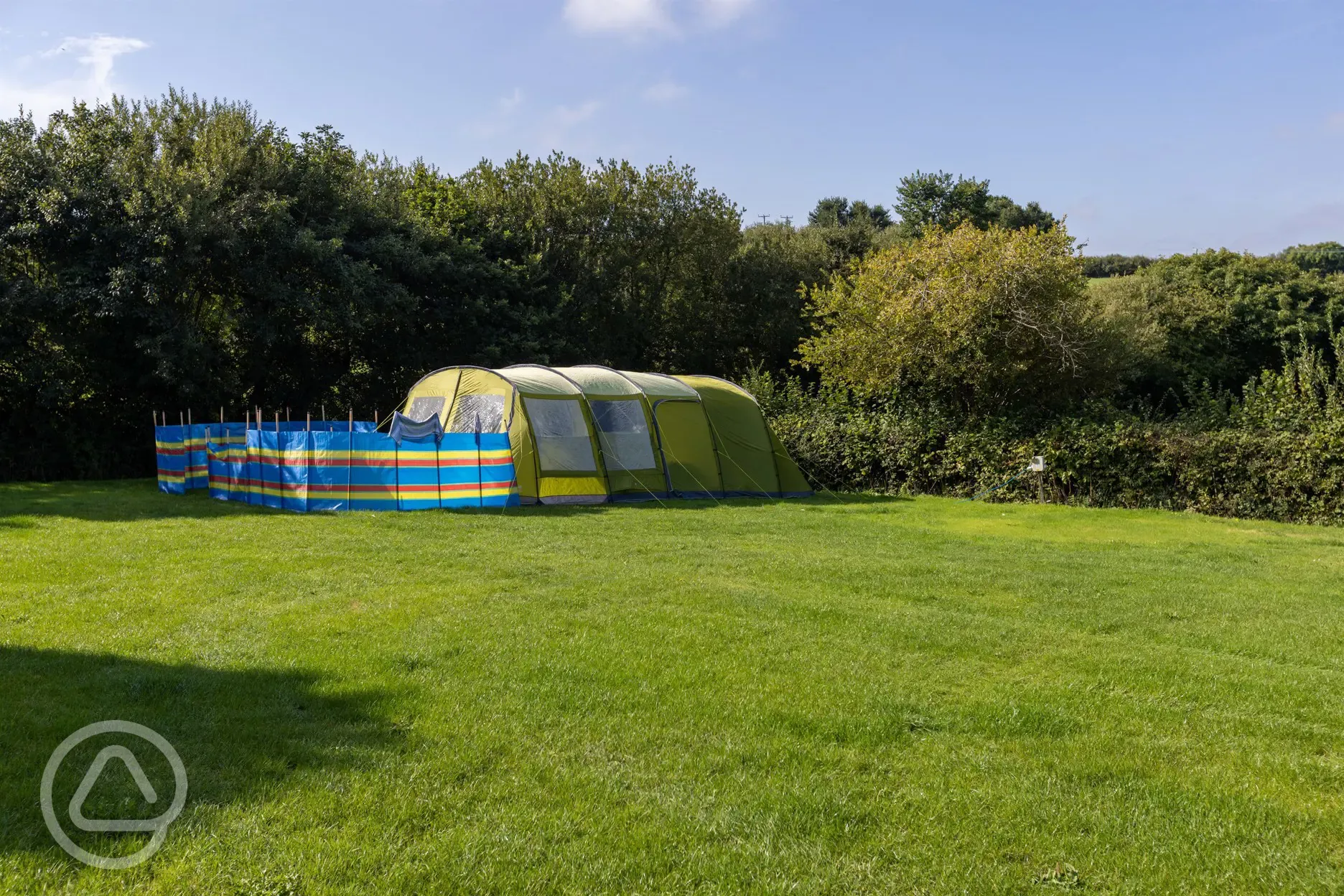 Tent on electric grass pitches at Cornish Coasts Caravan and Camping Park