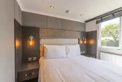 Ensuite glamping cabin king size bedroom with bedding