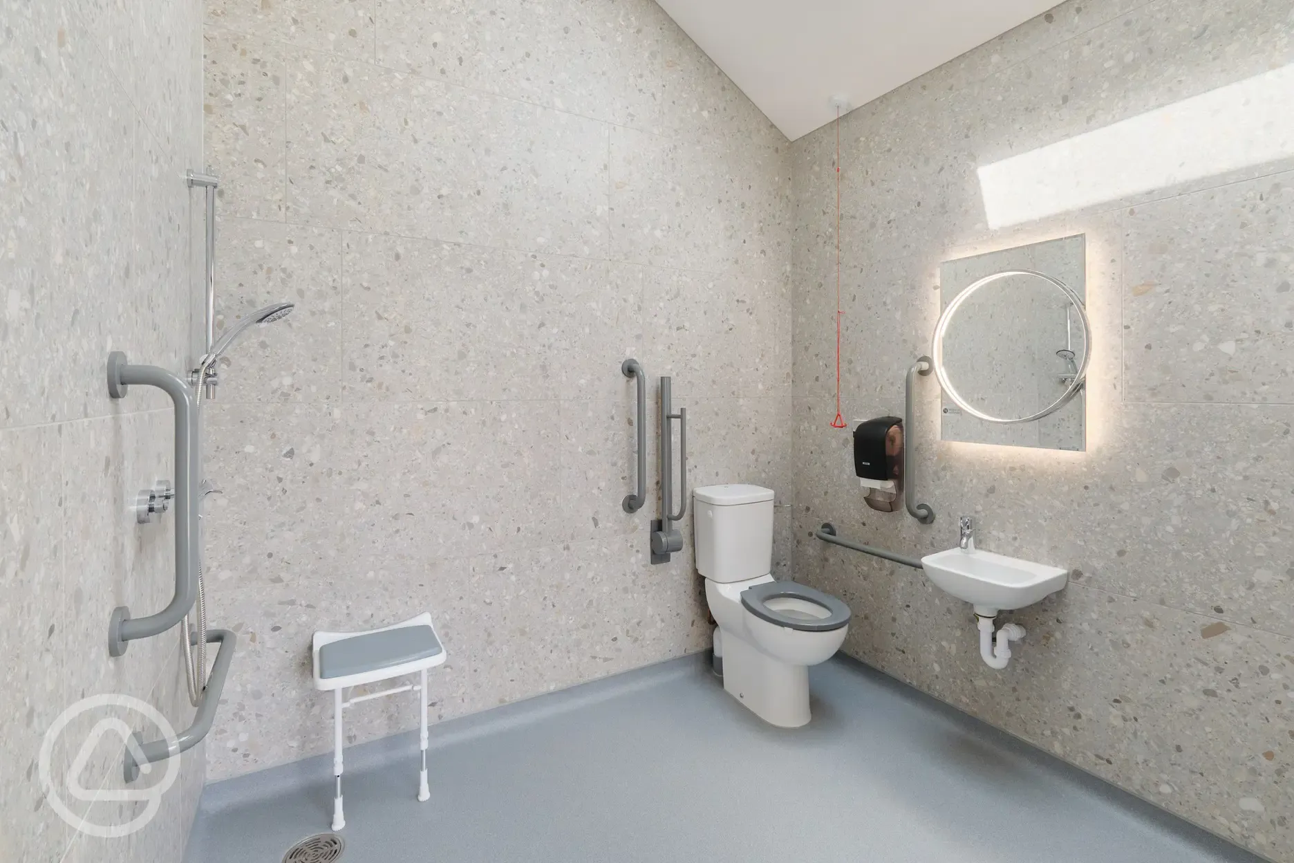 Accessible bathroom with a seat and handrails