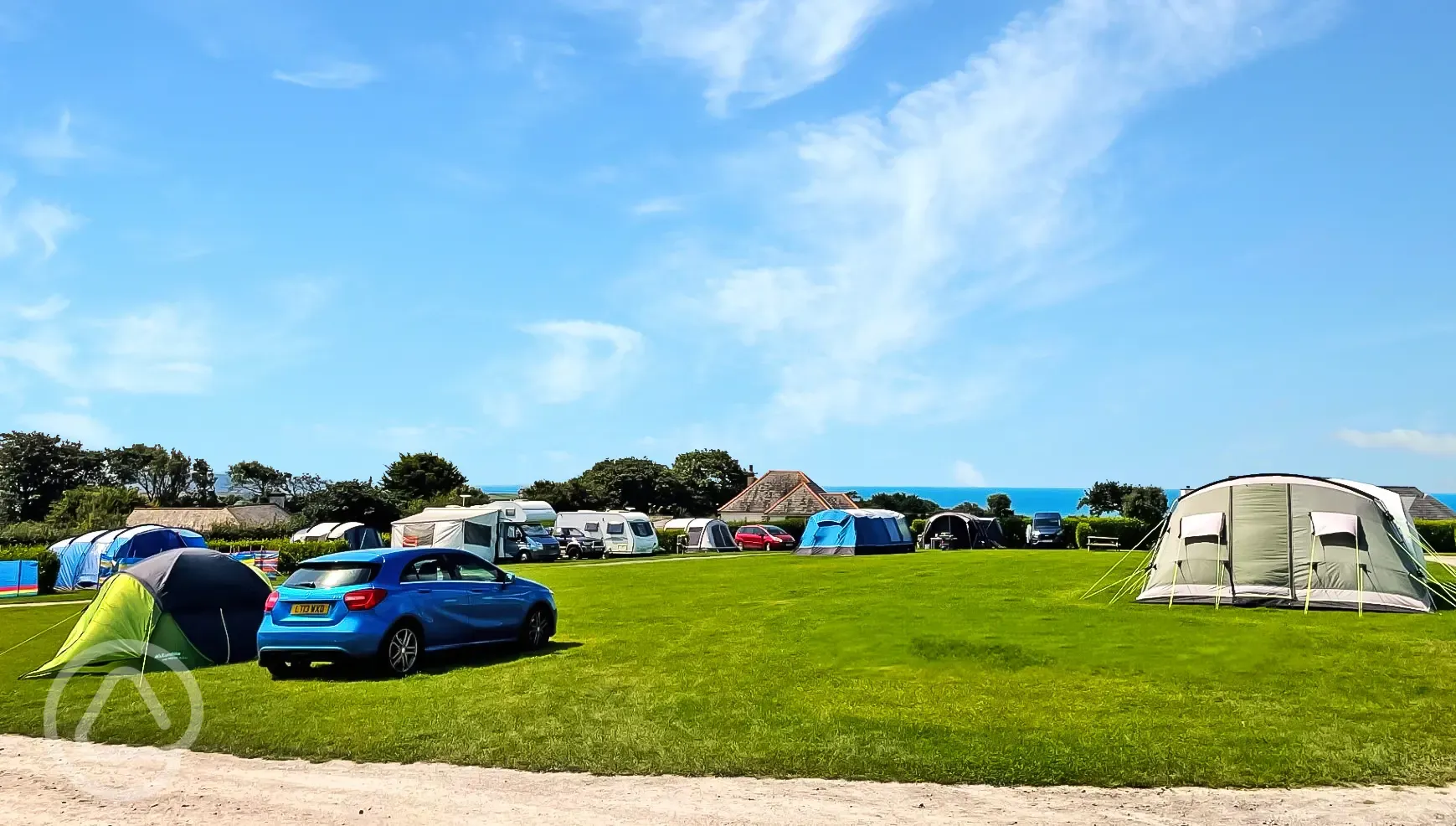 Tents and tourers on grass pitches with sea views