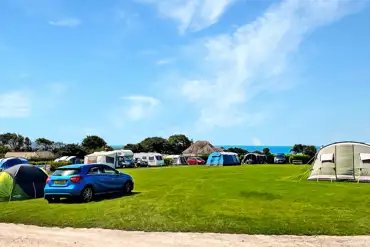 Tents and tourers on grass pitches with sea views