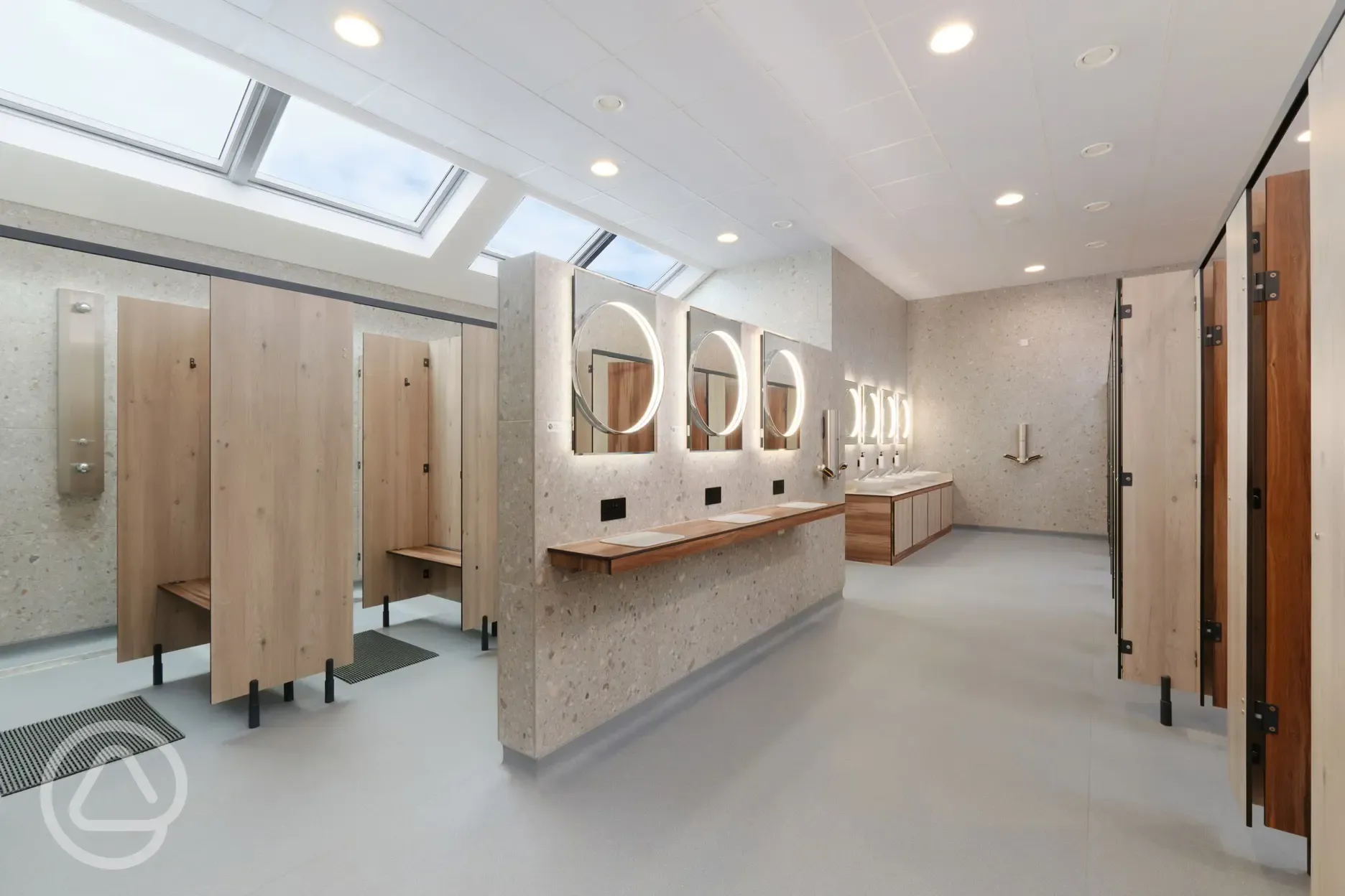 Ladies showers and toilets with sinks, mirrors, sockets and vanity area