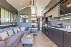 Ensuite glamping cabin interior with kitchen, sofa bed, king size and twin beds