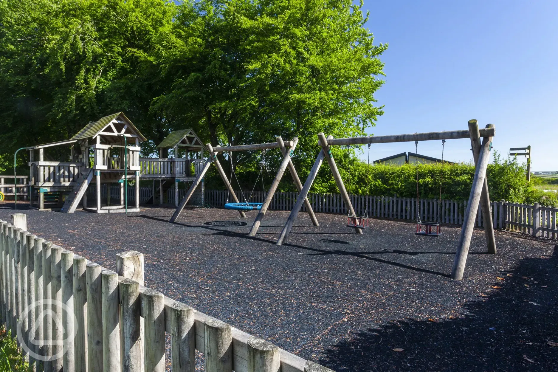 Children's playground with climbing frame and swings