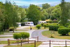 Fully serviced hardstanding pitches surrounded by trees and hedges