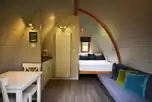 Premier glamping pod interior with a double bed and double sofa bed 