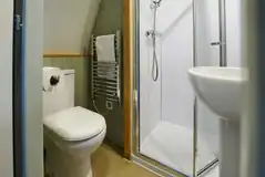 Ensuite toilet, shower, and handwashing sinks in the premier glamping pods