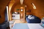 Deluxe mega pod with a small kitchenette, a double sofa bed, and double bed