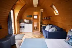 Deluxe mega pod with a small kitchenette, a double sofa bed, and double bed