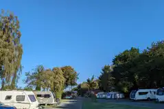 Fully serviced hardstanding touring pitches backed by trees Fully serviced hardstanding touring pitches backed by trees