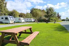 Fully serviced hardstanding touring pitches with picnic benches around site Fully serviced hardstanding touring pitches with picnic benches around site
