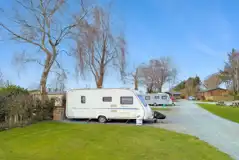 Fully serviced hardstanding touring pitches (5m x 7.5m) with grass areas between