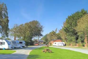 Fully serviced hardstanding touring pitches with grass areas between