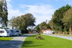 Fully serviced hardstanding touring pitches with picnic benches around site Fully serviced hardstanding touring pitches with picnic benches around site