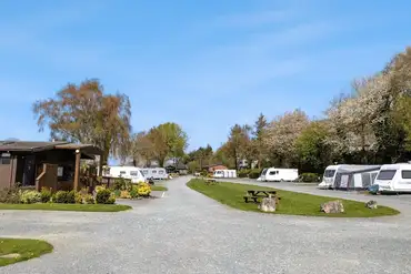 Fully serviced hardstanding touring pitches with grass areas between