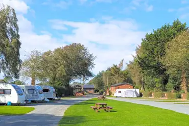 Fully serviced hardstanding touring pitches with grass areas between