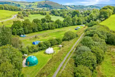 Aerial of glamping units and camping field