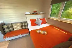 Shepherd's huts with a double bed, single sofa bed, TV and dining area